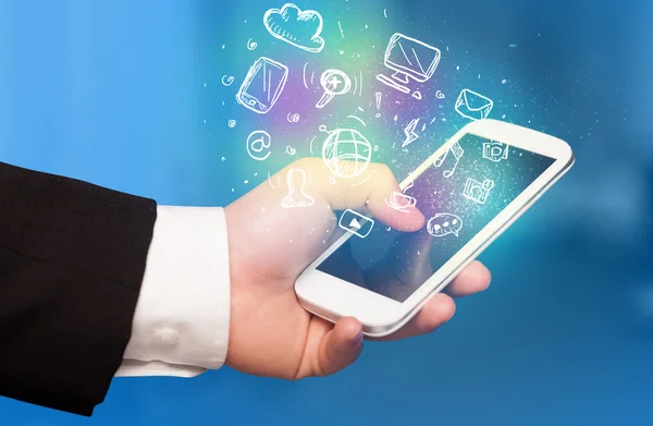Hand holding smartphone with media icons — Stock Photo, Image