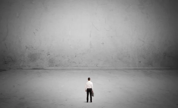 Small business person in large empty space — Stock Photo, Image