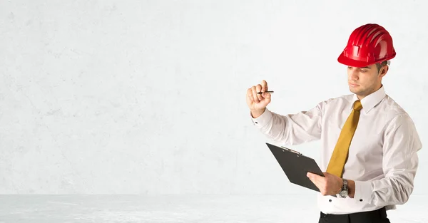 Young architect drawing in empty space — Stock Photo, Image