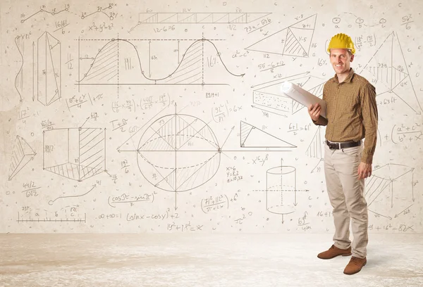Handsome engineer calculating with hand drawn background — Stock Photo, Image