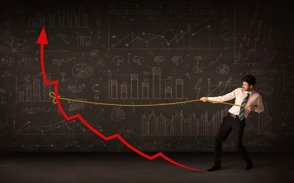 Zakenman trekt een rode pijl rechtop met een touw — Stockfoto