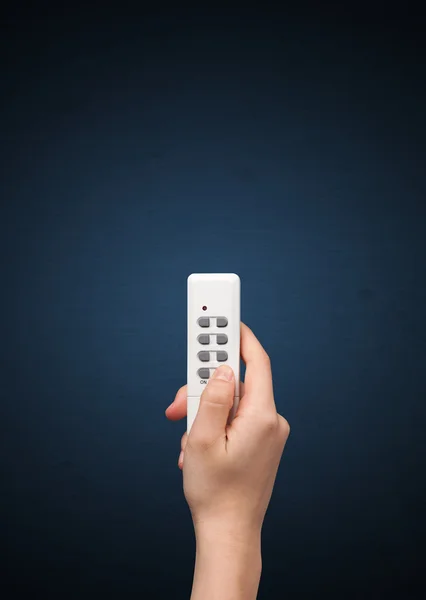 Hand with remote control — Stock Photo, Image