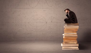 Kitaplar üzerinde oturan işadamı