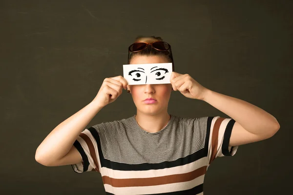 Silly youngster looking with hand drawn eye paper — Stock Photo, Image