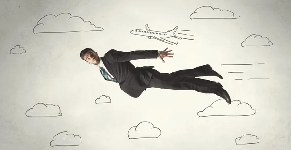 Cheerful business person flying between hand drawn sky clouds — Stock Photo, Image