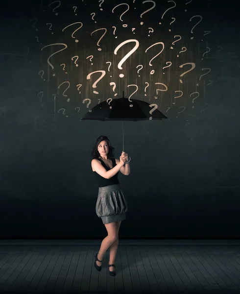 Businesswoman with umbrella and a lot of drawn question marks — Stock Photo, Image