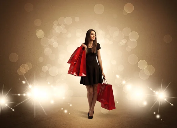 Compras señora con bolsas en luces brillantes —  Fotos de Stock