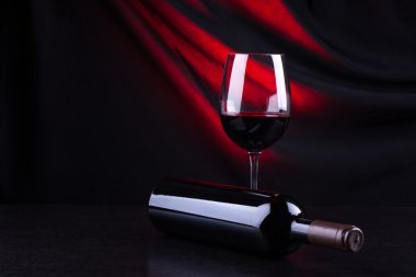 Kırmızı şarap kadehi ve şişe.