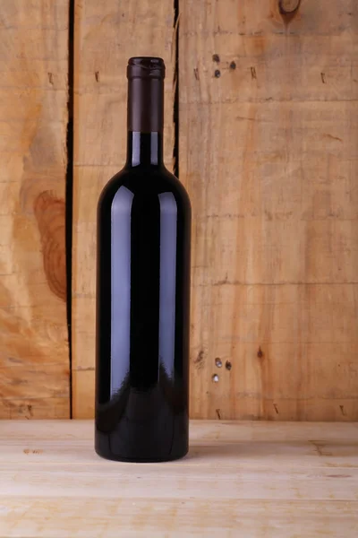 Wine bottle on wood — Stock Photo, Image