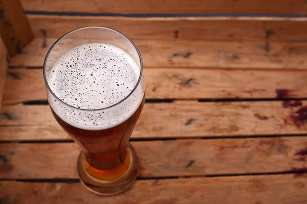 Tall glass of beer in a crate — Stock Photo, Image