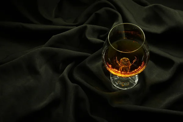 Brandy on black cloth — Stock Photo, Image