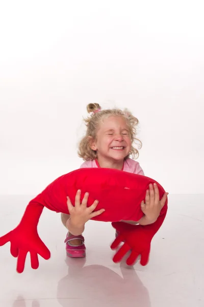 Little girl with heart shaped pillow — Stock Photo, Image