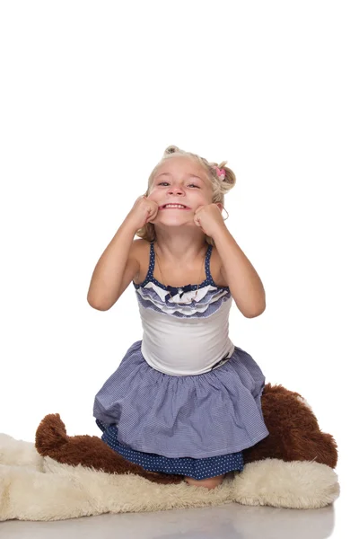 Little girl sitting on dog toy — Stock Photo, Image