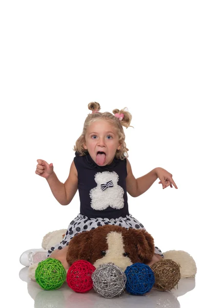 Little girl sitting on dog toy — Stock Photo, Image