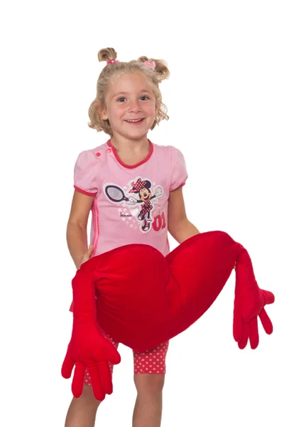 Little girl with heart shaped pillow — Stock Photo, Image