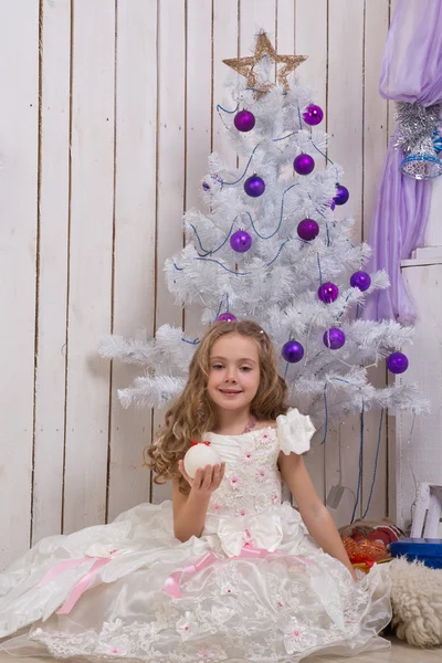 Little girl over fir tree — Stock Photo, Image