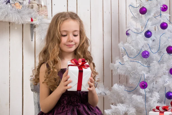 Little girl with christmas present — Stock Photo, Image