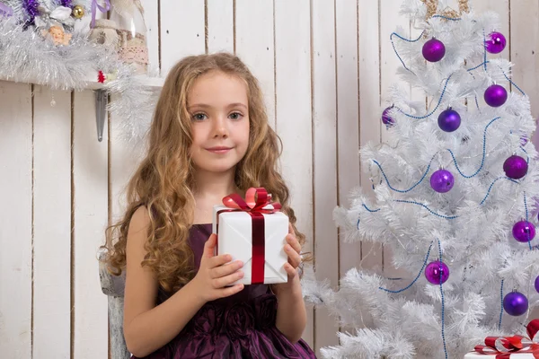 Little girl with christmas present — Stock Photo, Image