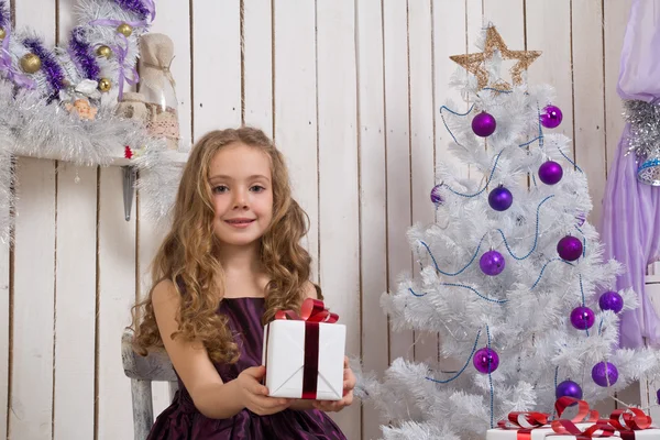 Little girl with christmas present — Stock Photo, Image