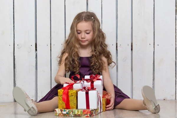 Happy little girl with gift boxes — Stock Photo, Image