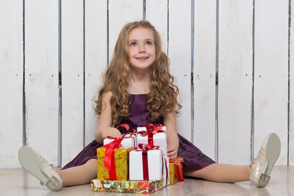 Happy little girl with gift boxes — Stock Photo, Image