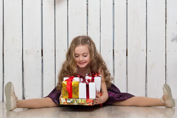 Happy little girl with gift boxes — Stock Photo, Image