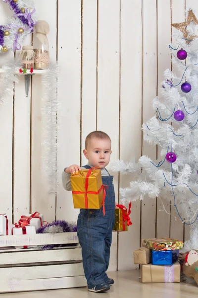 Baby boy under Christmas fir tree — Stock Photo, Image