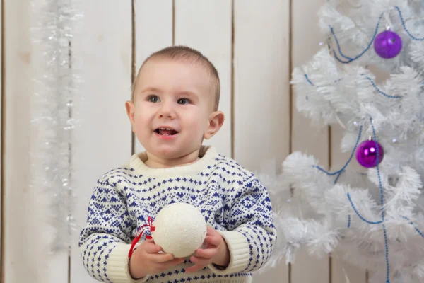 Baby boy under Christmas fir tree — Stock Photo, Image