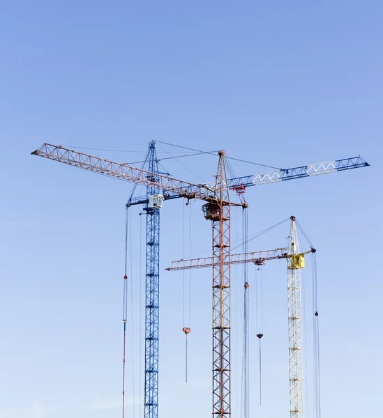 Industrial landscape with silhouettes of cranes on the sky backg — Stock Photo, Image