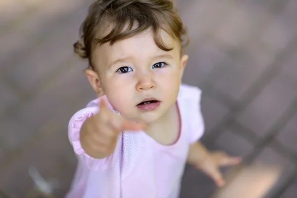 Cute baby girl looking up at the camera — Stock Photo, Image