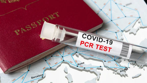 COVID-19, travel and test concept, tube for coronavirus PCR testing and tourist passport on Europe map. Coronavirus diagnostics due to restrictions and lockdown. World tourism hit by corona virus.