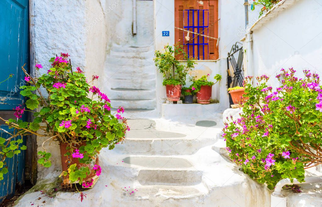 Street in Plaka district, Athens, Greece. Plaka is tourist attraction of Athens. Beautiful sidewalk stairway near Acropolis in Anafiotika quarter in Athens. Cozy stairs with flowers between old houses.