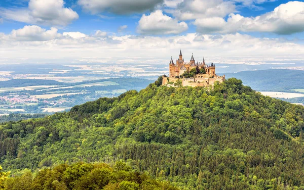 Landscape with Hohenzollern Castle on mountain top, Germany. It is landmark of Swabian Alps. Scenic panorama of German burg, old castle in summer. Nice view of Gothic castle in Stuttgart vicinity.