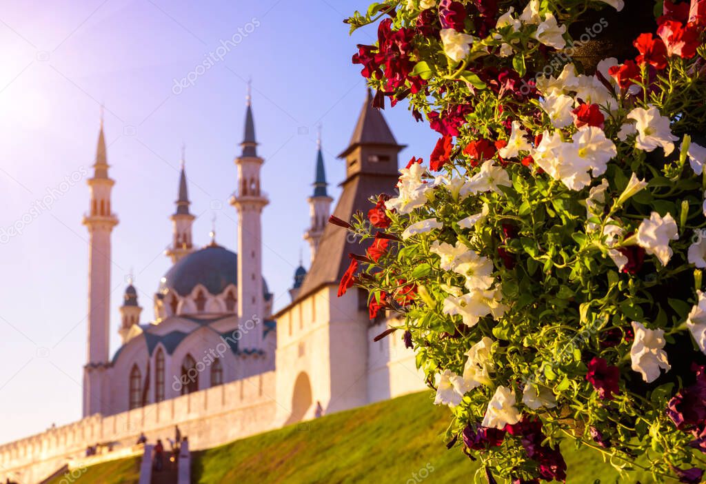 Kazan Kremlin in summer, Tatarstan, Russia. It is top tourist attraction of Kazan. Beautiful scenic view of white fortress and mosque, focus on flowers. Historical architecture in Kazan city center.