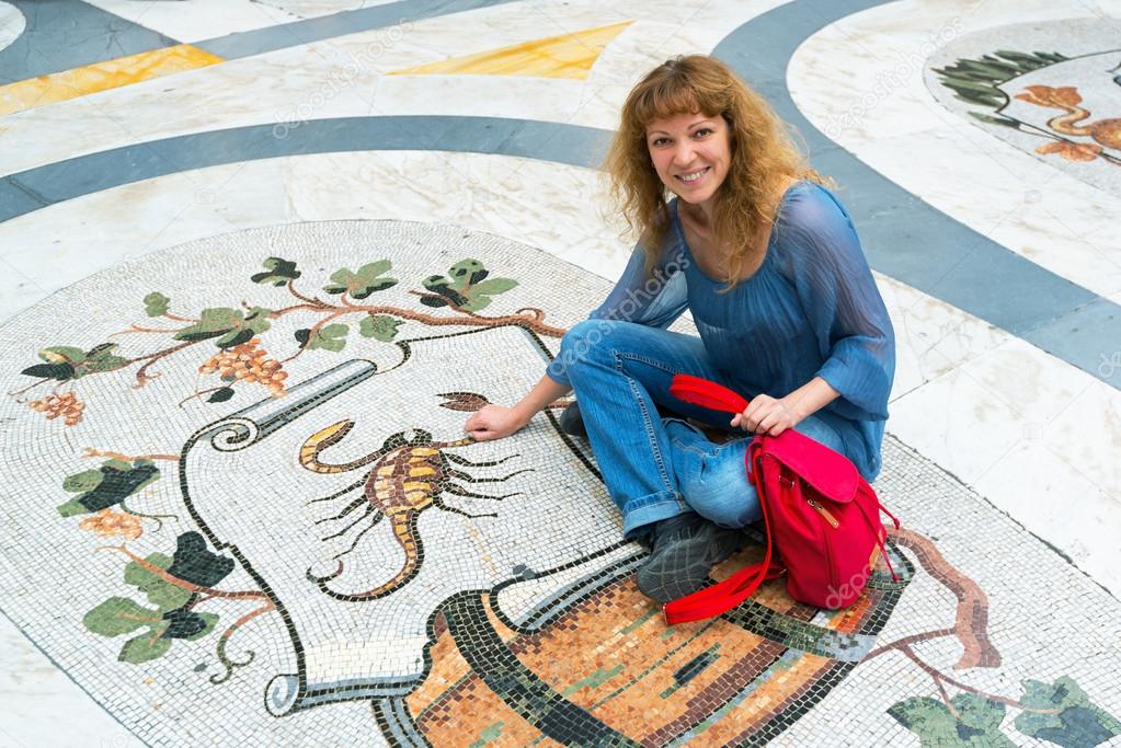 Female tourist on the Zodiac sign Scorpio in Galleria Umberto I 