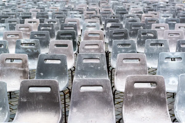 Empty old gray plastic chairs — Stock Photo, Image