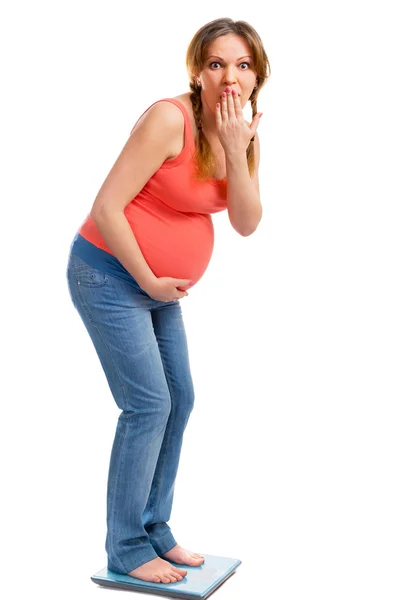 A cute pregnant woman shocked on scale — Stock Photo, Image