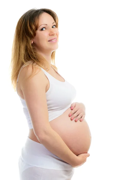 Eine lächelnde süße schwangere Frau — Stockfoto