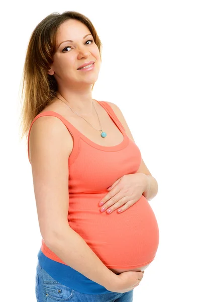 Een lachende zwangere vrouw geïsoleerd op wit — Stockfoto