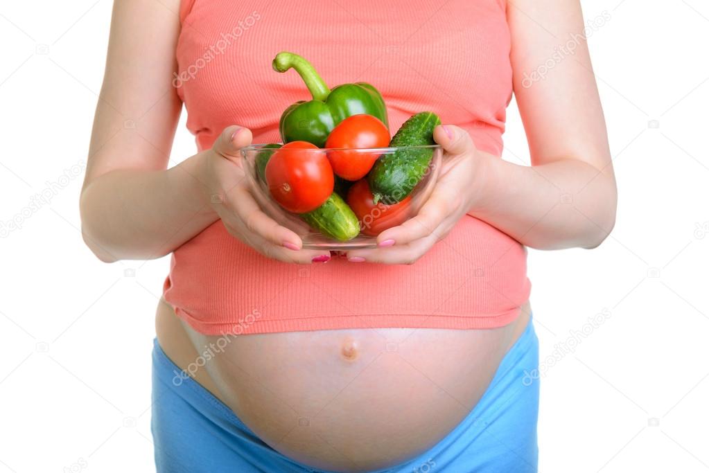 Pregnant woman with fresh vegetables