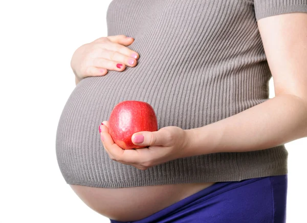 Těhotná žena drží červené jablko — Stock fotografie