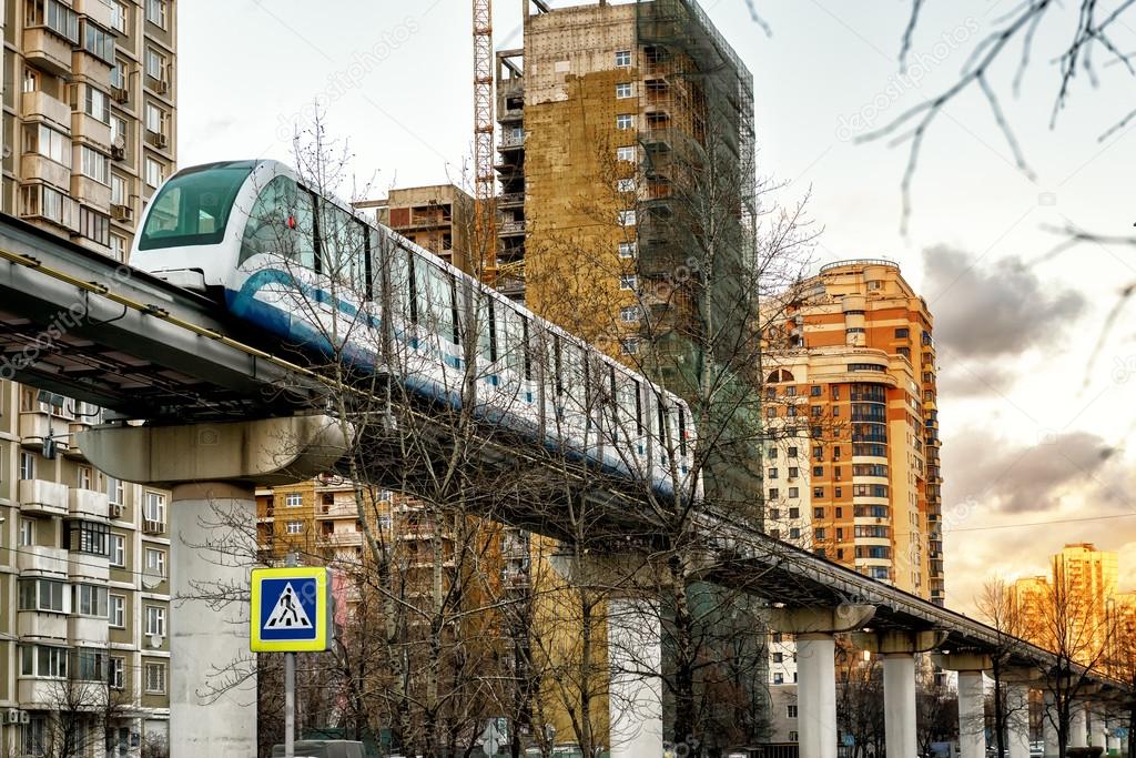 A monorail train runs above the street in Moscow