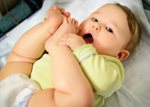 Baby hugged his legs — Stock Photo, Image