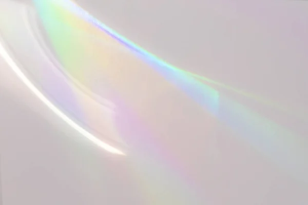 Blurred rainbow light refraction texture on white wall — Stock Photo, Image