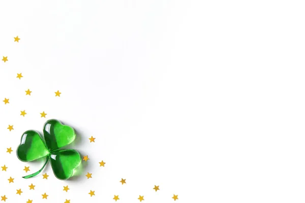 Shamrock symbol made of green glass hearts lying on white background — Stock Photo, Image