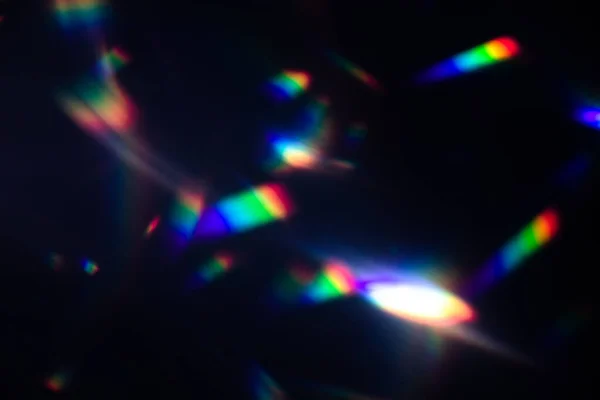 colorful warm rainbow crystal light leaks on black background