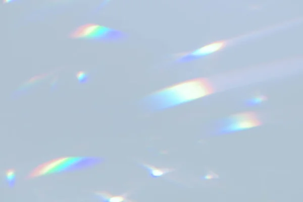 Blurred rainbow light refraction texture on white wall — Stock Photo, Image