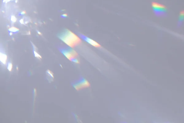 Blurred rainbow light refraction texture on white wall — Stock Photo, Image