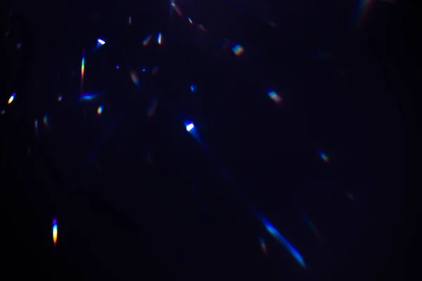 Colorful warm rainbow crystal light leaks on black background — Stock Photo, Image