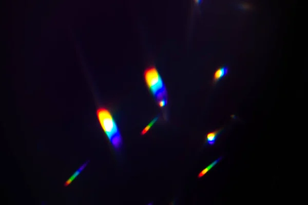 Kleurrijke warme regenboog kristal licht lekt op zwarte achtergrond — Stockfoto